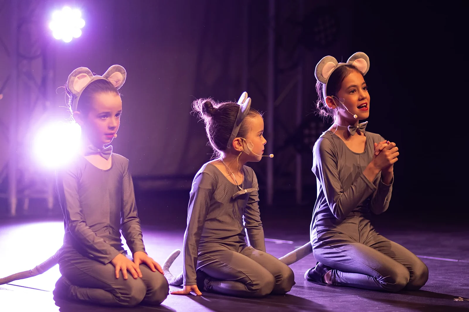 Young KWA actors in mouse costumes on stage