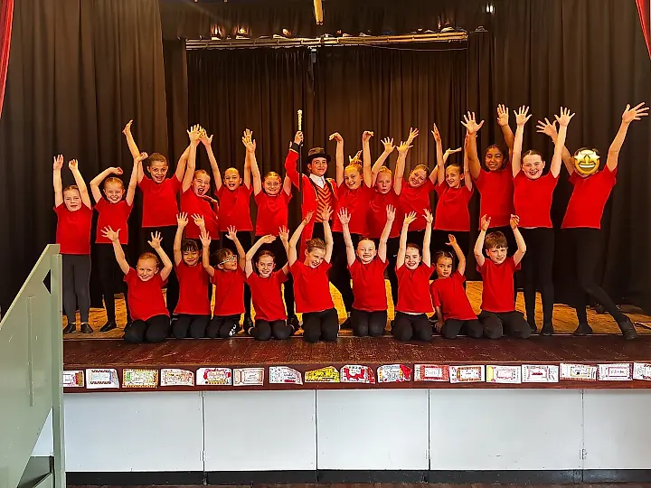 KWA dance troupe performing on stage in matching costumes